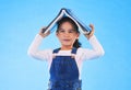 School, head and portrait of child with book for knowledge or learning isolated in a studio blue background. Clever