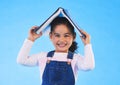 School, head and portrait of kid with book for knowledge or learning isolated in a studio blue background. Clever, smart