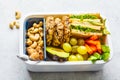 School healthy lunch box with sandwich, cookies, fruits and avocado on white background Royalty Free Stock Photo