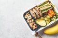 School healthy lunch box with sandwich, cookies, fruits and avocado on white background Royalty Free Stock Photo