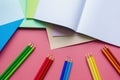 School and hobby concepts. Colored paper sheets, colored pencils and notebook. Copy space Royalty Free Stock Photo