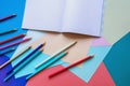 School and hobby concepts. Colored paper sheets, colored pencils and notebooks. Copy space Royalty Free Stock Photo