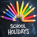 School Holidays: Colorful Pencils on Chalkboard for Educational Fun Royalty Free Stock Photo