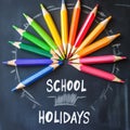 School Holidays: Colorful Pencils on Chalkboard for Educational Fun Royalty Free Stock Photo