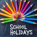 School Holidays: Colorful Pencils on Chalkboard for Educational Fun Royalty Free Stock Photo