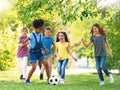 School holidays. Group of children playing football outdoors