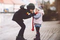 School kid boy and brother warming hands of little sister, toddler girl on cold snowy grey winter day. Family, two Royalty Free Stock Photo