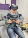 School kid boy experiencing virtual reality video game. Surprised little boy looking in VR glasses. Digital activity for children