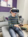 School kid boy experiencing virtual reality video game. Surprised little boy looking in VR glasses. Digital activity for