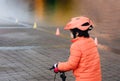 School kid learns to ride a bike in the Park, Outdoor Portrait of a young boy on bicycle,  Child in helmet riding a cycling in the Royalty Free Stock Photo