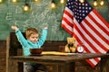 School kid at lesson in 4th of july. Happy independence day of the usa. Back to school or home schooling. Little boy eat Royalty Free Stock Photo