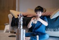 School kid making spaceship for his homework, Happy child boy sitting on the floor playing with rocket toy, Art and craft activity Royalty Free Stock Photo