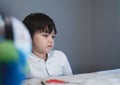 School kid in self isolation looking down with sad face, Bored Child  looking out deep in thought, Young Boy stay at home during Royalty Free Stock Photo