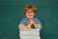 School kids against green chalkboard. Elementary school and education. Talented child. First school day. Kids gets ready Royalty Free Stock Photo