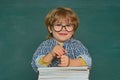 School kids against green chalkboard. Elementary school and education. Talented child. First school day. Kids gets ready Royalty Free Stock Photo