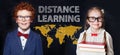 School kids and distance education concept on blackboard background Royalty Free Stock Photo
