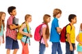 School kids go in line with backpacks profile view Royalty Free Stock Photo