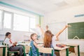 School kids have fun in class and throwing paper in air Royalty Free Stock Photo