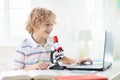 School kids with microscope. Science class Royalty Free Stock Photo