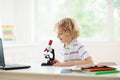 School kids with microscope. Science class Royalty Free Stock Photo