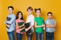 School kids with notebooks over yellow background Royalty Free Stock Photo