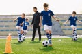 School Kids Play Team Sports on Soccer Stadium. Happy Boys Kicking Football Balls on Grass Field Royalty Free Stock Photo