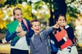 School kids pointing with finger away and looking at something funny Royalty Free Stock Photo