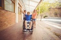 School kids pushing a boy on wheelchair Royalty Free Stock Photo