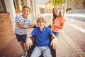 School kids pushing a boy on wheelchair Royalty Free Stock Photo