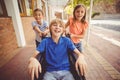 School kids pushing a boy on wheelchair Royalty Free Stock Photo