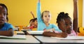 School kids raising hand in classroom