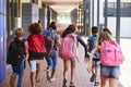 School kids running in elementary school hallway, back view Royalty Free Stock Photo