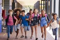 School kids running in elementary school hallway, front view Royalty Free Stock Photo