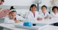 School kids, science and teacher with beaker in class for learning, information or experiment for knowledge. Children Royalty Free Stock Photo