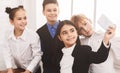 School kids taking selfie on smartphone in corridor Royalty Free Stock Photo