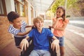 School kids talking to a boy on wheelchair Royalty Free Stock Photo