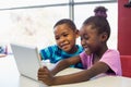 School kids using a digital tablet in classroom