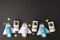 School kindergarten crafts, paper spaceship, shuttle, astronaut on black background with copy space for text. Party, start up