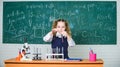 School laboratory. Girl smart student conduct school experiment. School pupil study chemical liquids. School chemistry Royalty Free Stock Photo