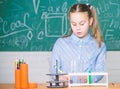 School laboratory. Girl smart student conduct school experiment. School pupil study chemical liquids. School chemistry