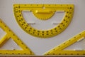 School large yellow protractor and two triangles