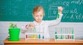 School lesson. Girl cute school pupil play with test tubes and colorful liquids. School chemical experiment. School Royalty Free Stock Photo