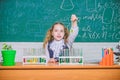 School lesson. Interesting approach to learn. Girl cute school pupil play with test tubes and colorful liquids. School Royalty Free Stock Photo