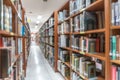 School library education blur interior background with blurry view of books on bookshelves in classroom aisle or study class room Royalty Free Stock Photo