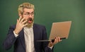 School lifehack. Teacher wear eyeglasses hold laptop surfing internet. Lot of information. Bearded man modern laptop