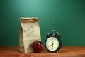 School Lunch, Apple and Clock on Desk at School