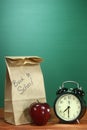 School Lunch, Apple and Clock on Desk at School Royalty Free Stock Photo