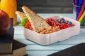 School lunch in a box, berries, nuts and a sandwich. Almonds, red currants and blueberries for a child s snack. Healthy