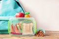 School lunch box with sandwich, vegetables, juice and almonds on table Royalty Free Stock Photo