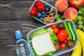 School lunch boxes with sandwich, fruits, vegetables and bottle of water and copy space Royalty Free Stock Photo